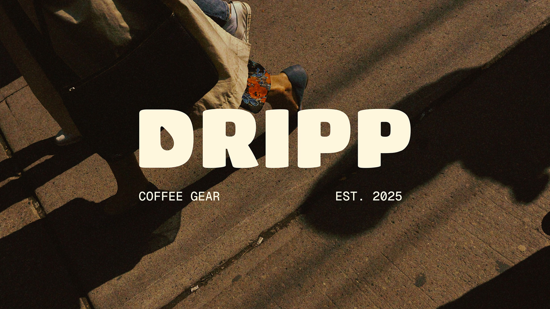 Header image of DRIPP Coffee Gear's logo on top of a photo of a woman walking on a sidewalk with her purse